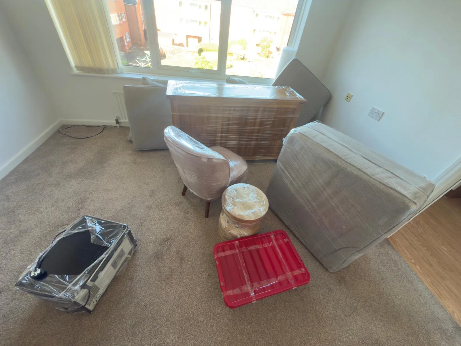 Packer wrapping kitchenware in boxes before a Manchester move
